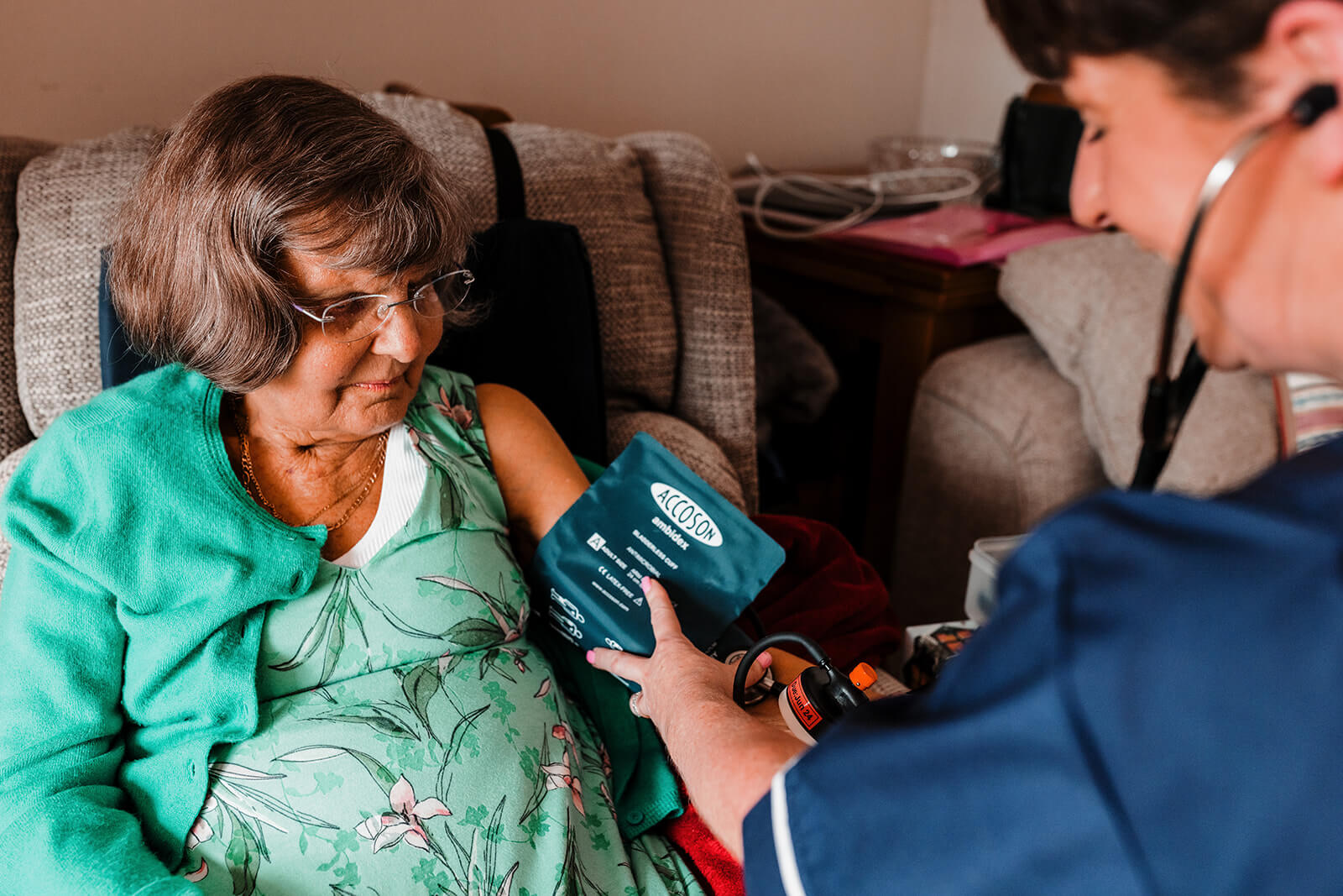 Nurse taking the blood pressure of a patient.