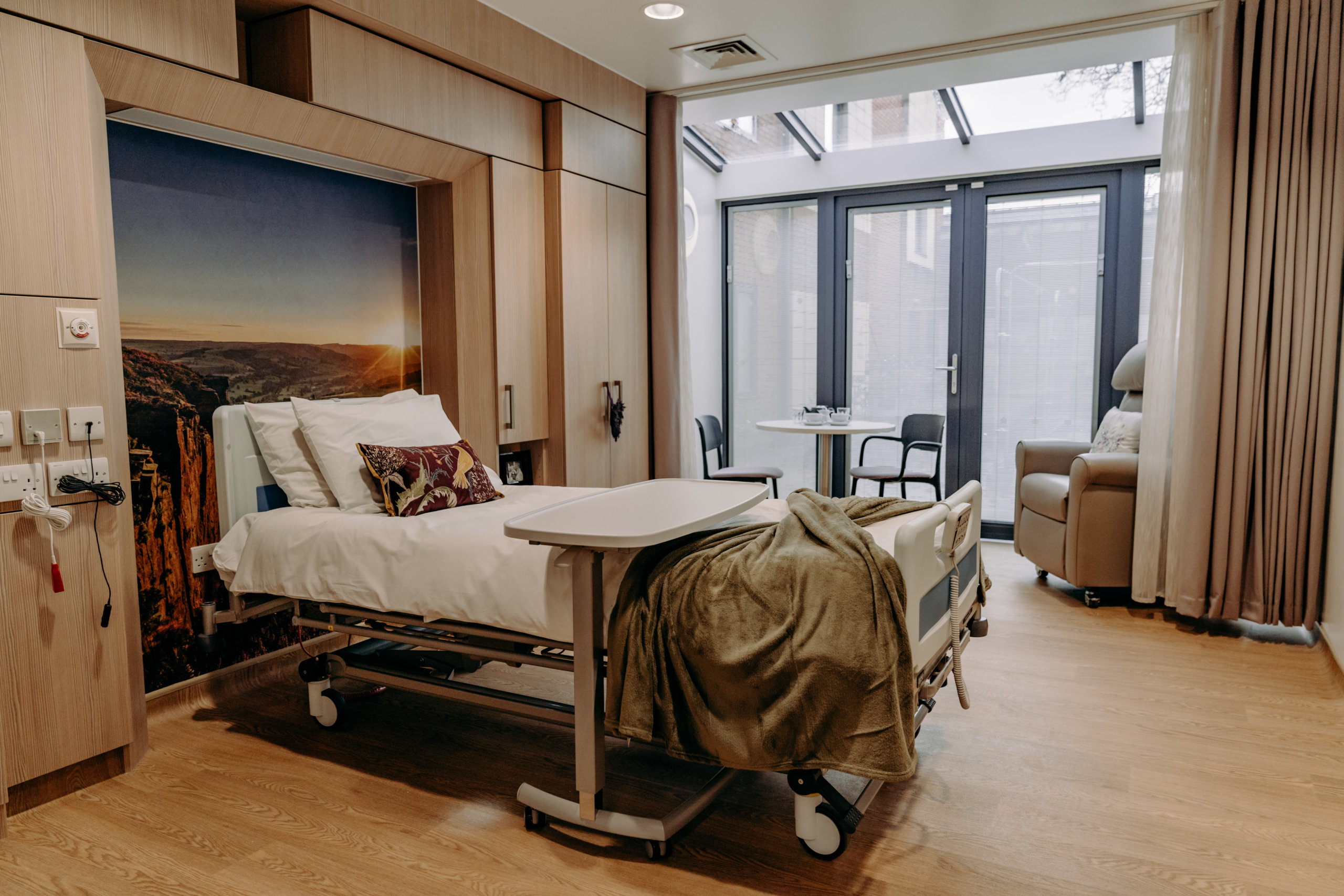 Room on the ward with a bed and patio doors