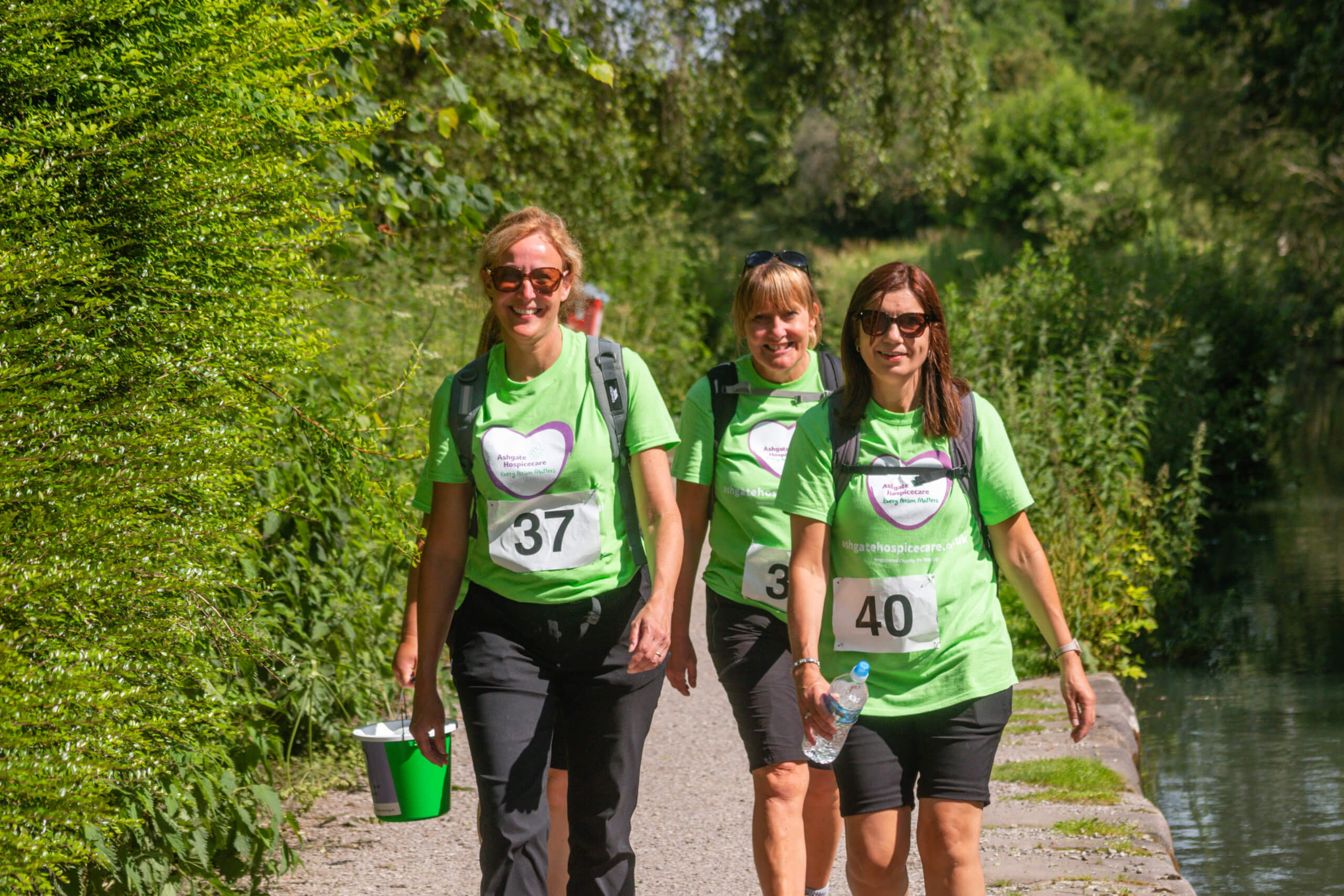 Group of ladies walking in the countryside with a collection bucket