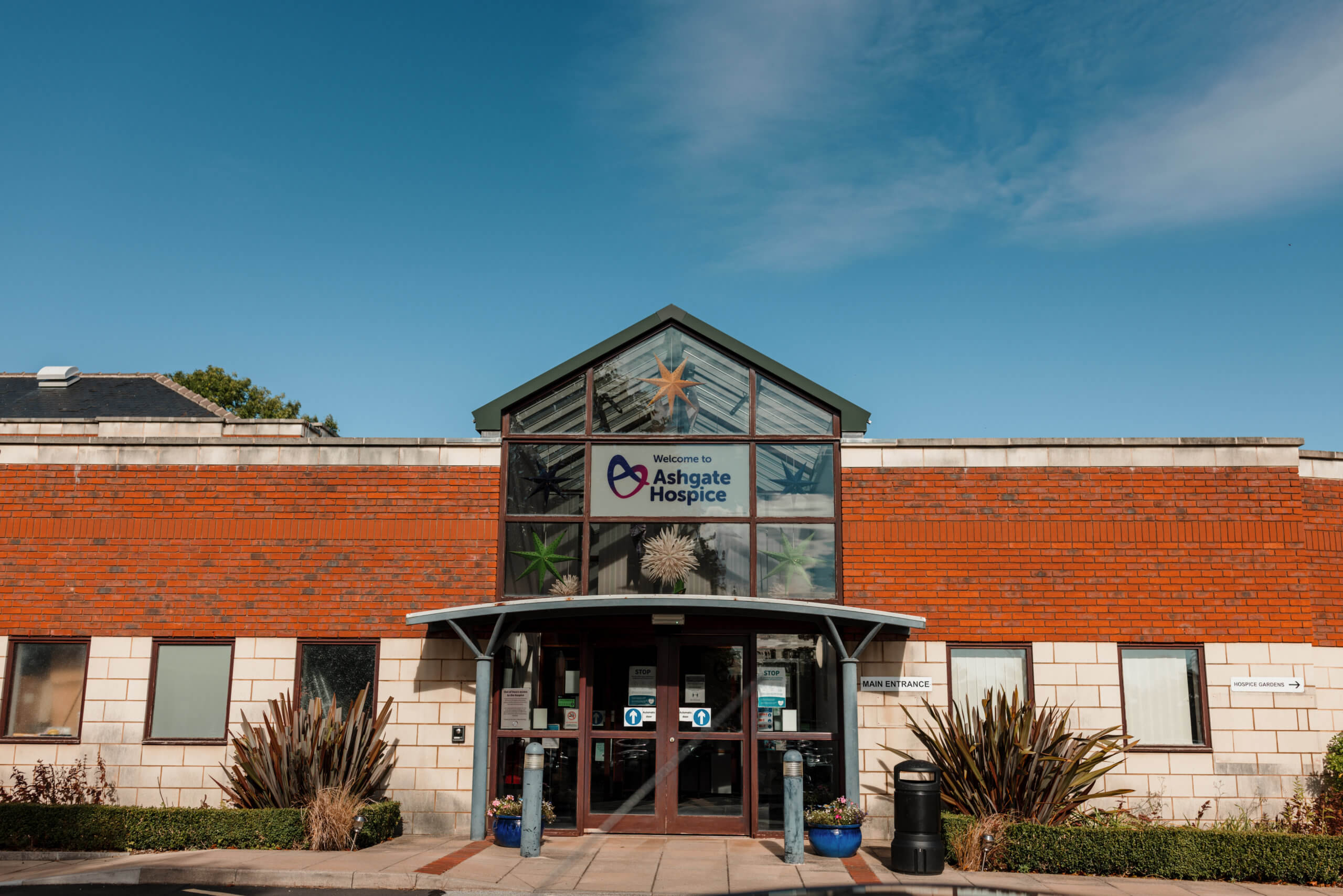 Main hospice building with blue sky behind