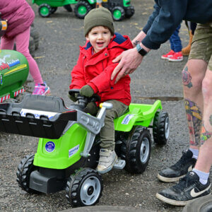 Child on a pedal tractor
