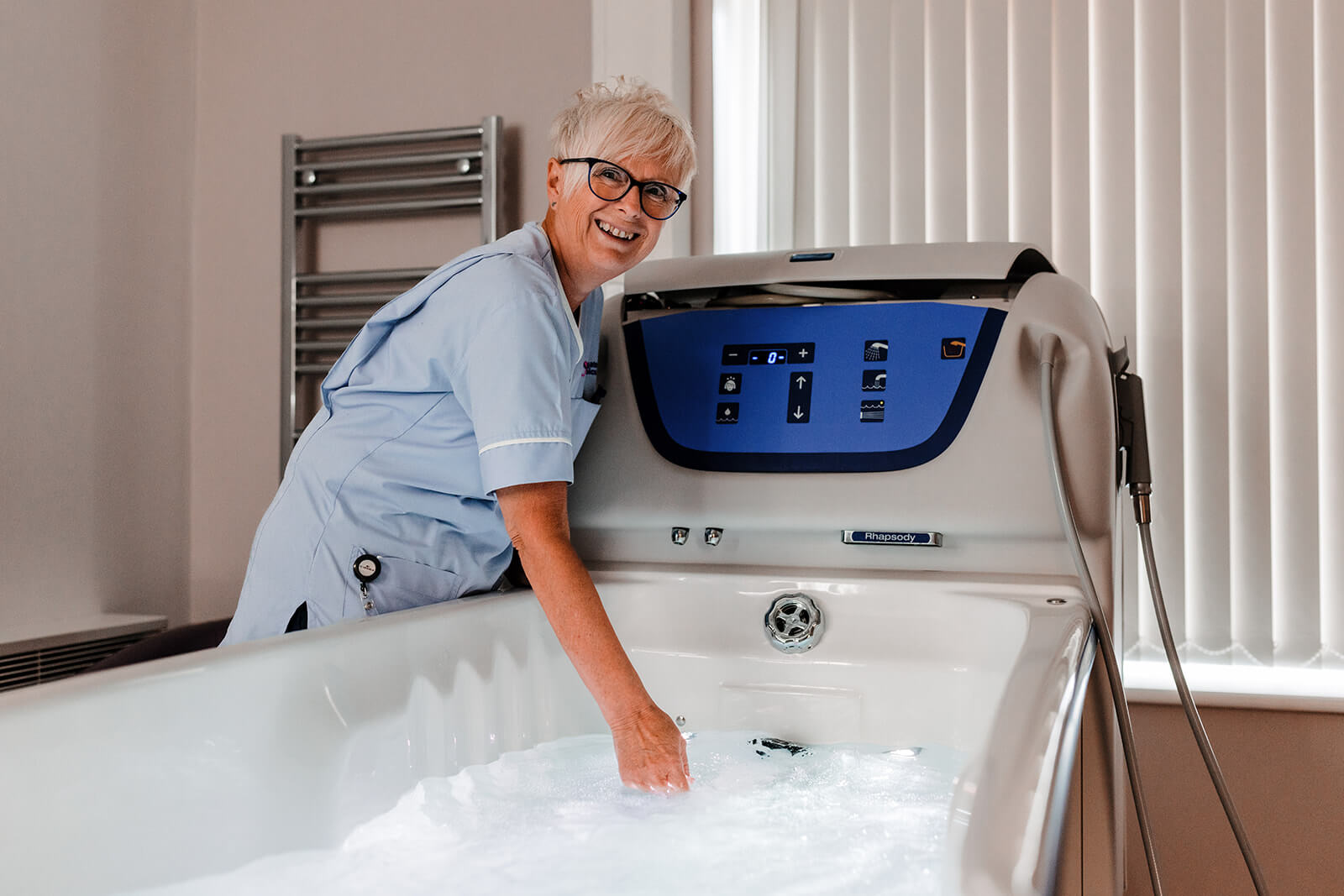 Healthcare Assistant running a bath