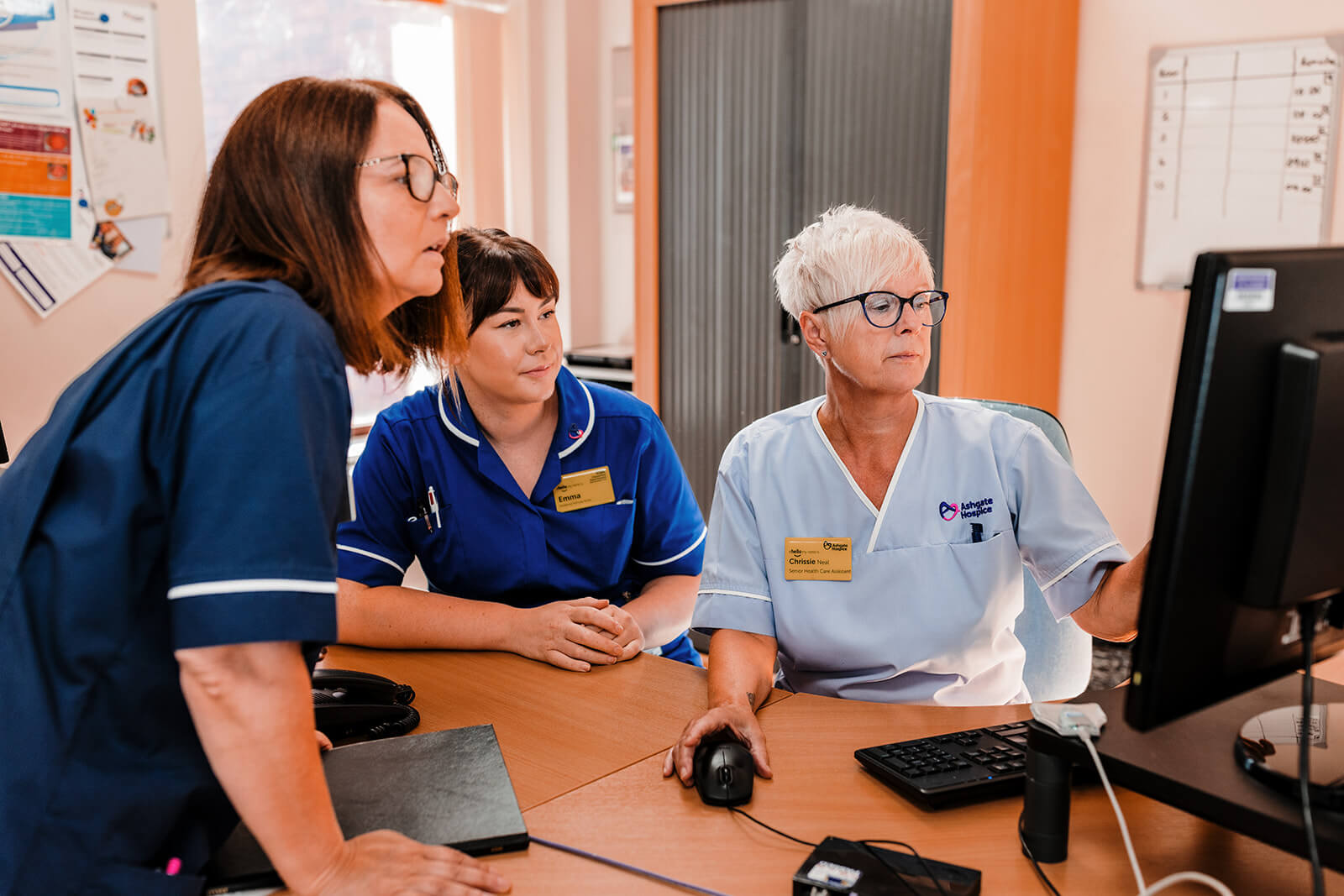 Inpatient Unit nurses looking at a computer screen