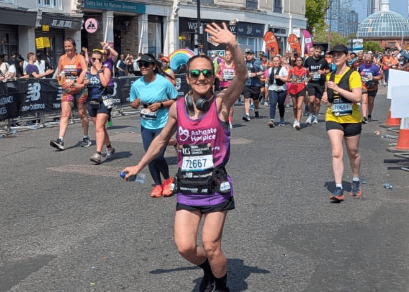 Woman running the London Marathon wearing an Ashgate Hospice running vest.