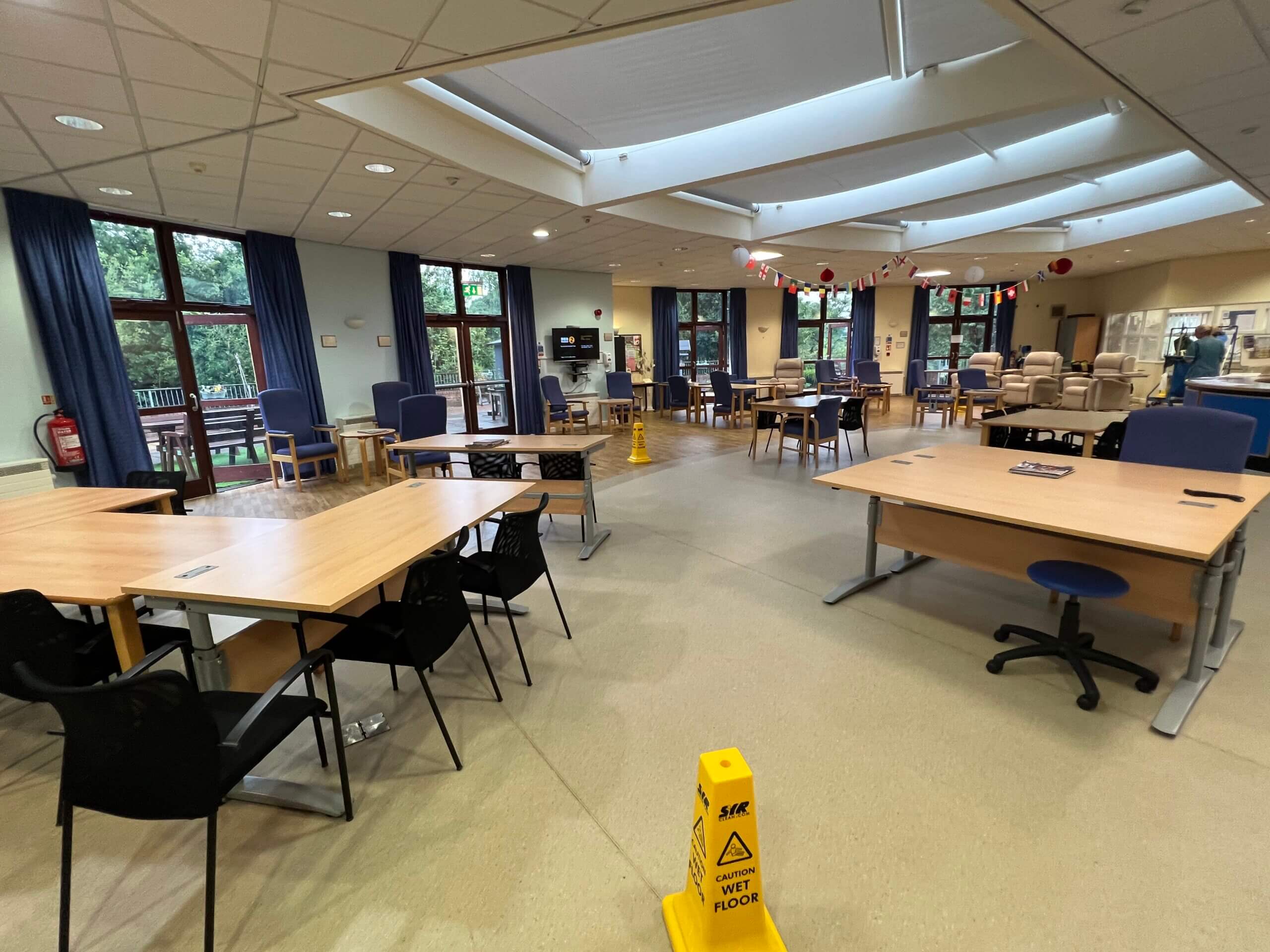 Image of Day Services with tables and chairs laid out around the room.