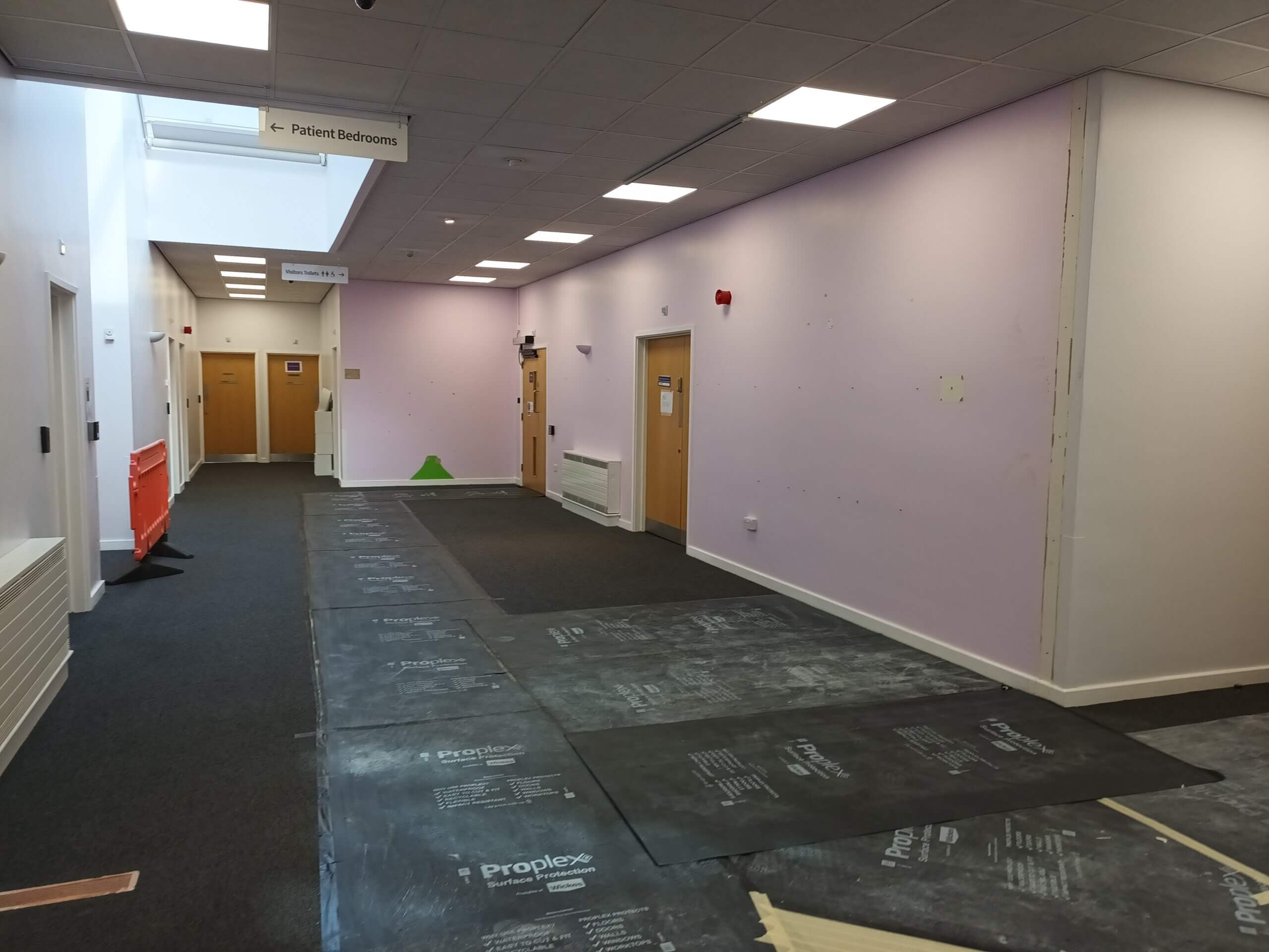 Area outside the Outpatient Suite near reception after two partial stud walls have been removed.