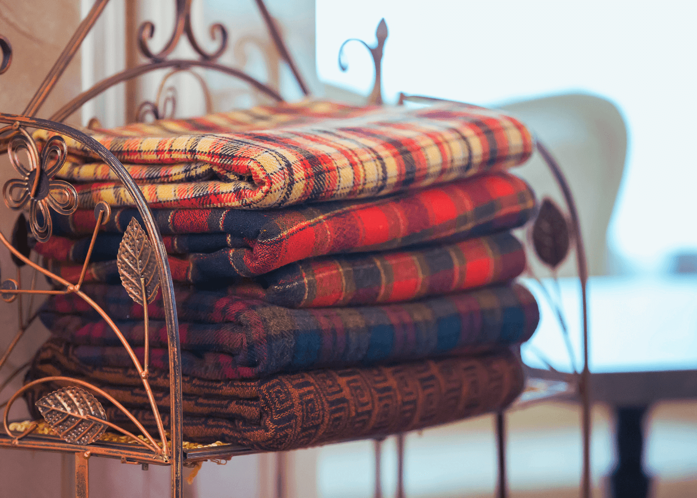 Pile of five blankets on a chair
