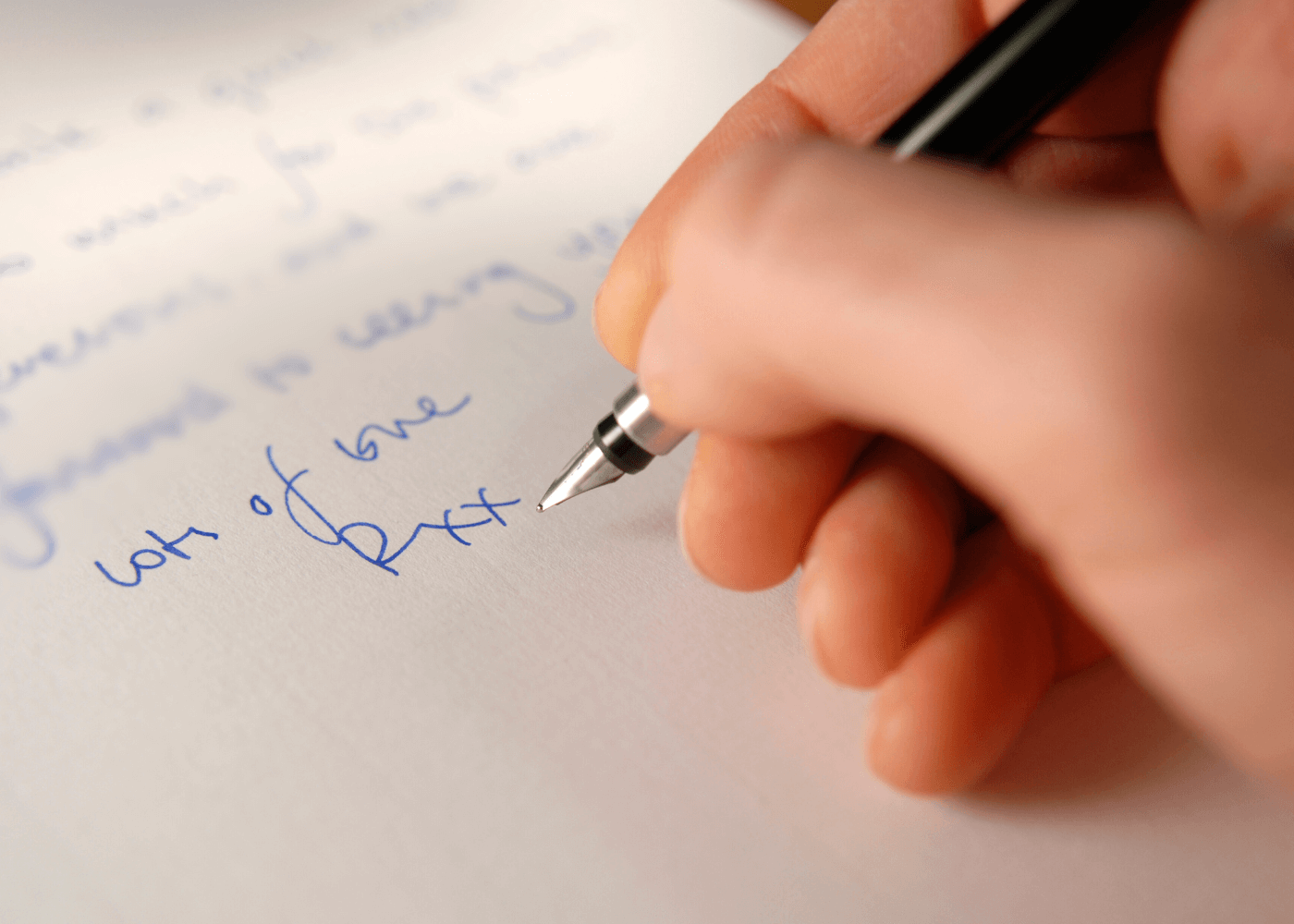 Person handwriting a letter