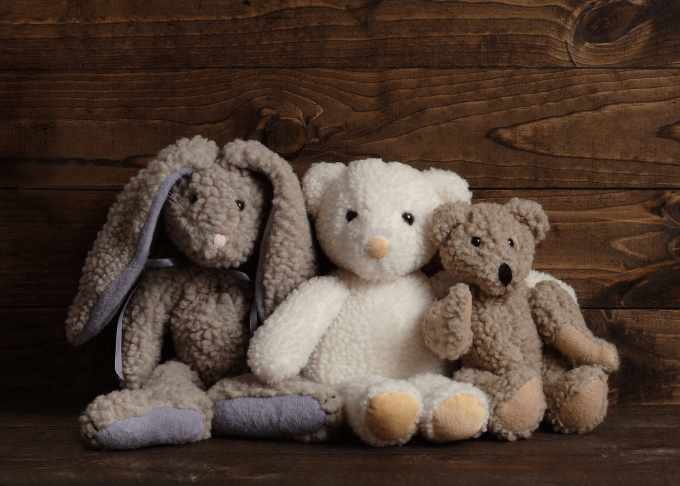 Three cuddly soft toys including two bears and a rabbit