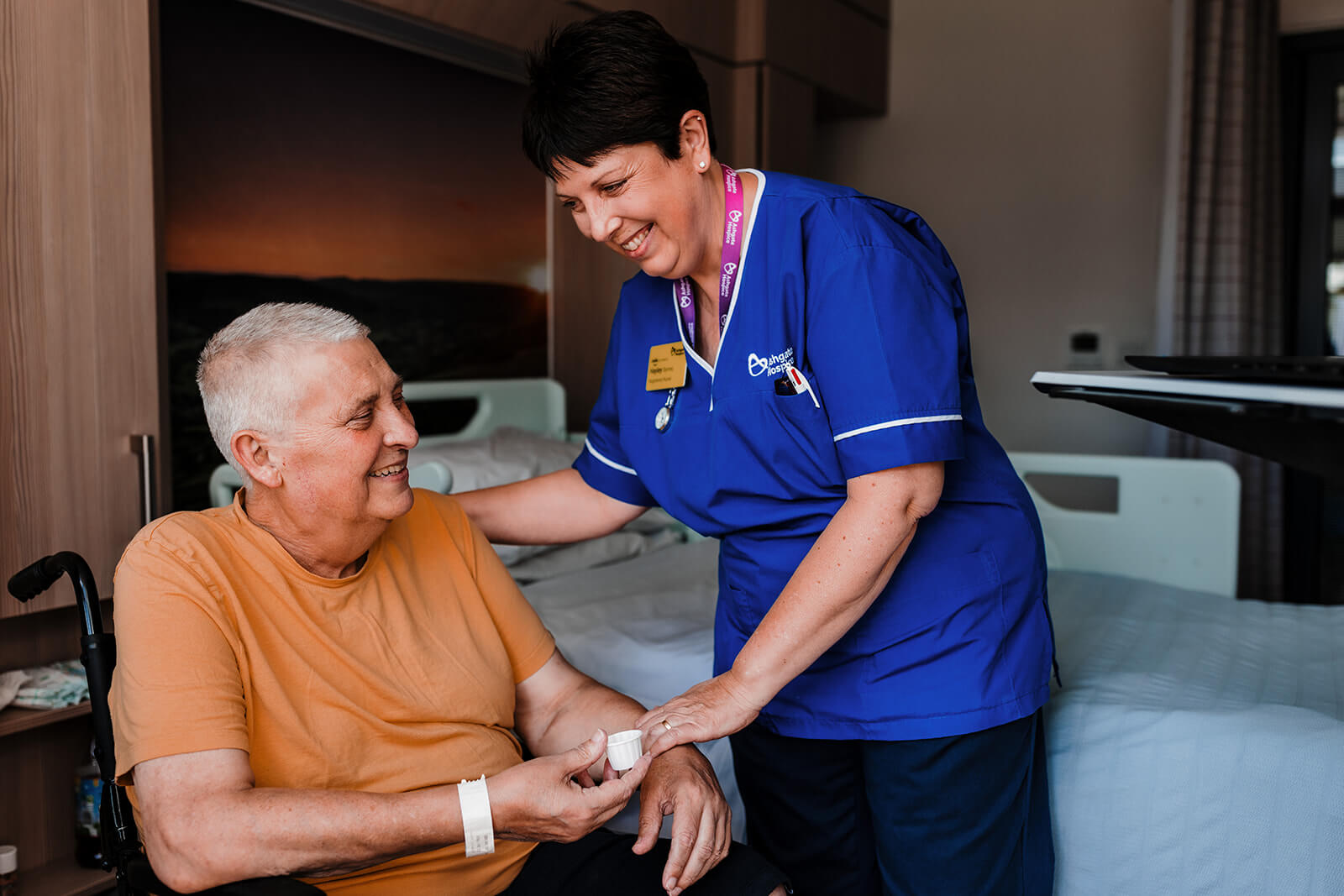 Nurse passing medication to a patient on the Ashgate Hospice Inpatient Unit.