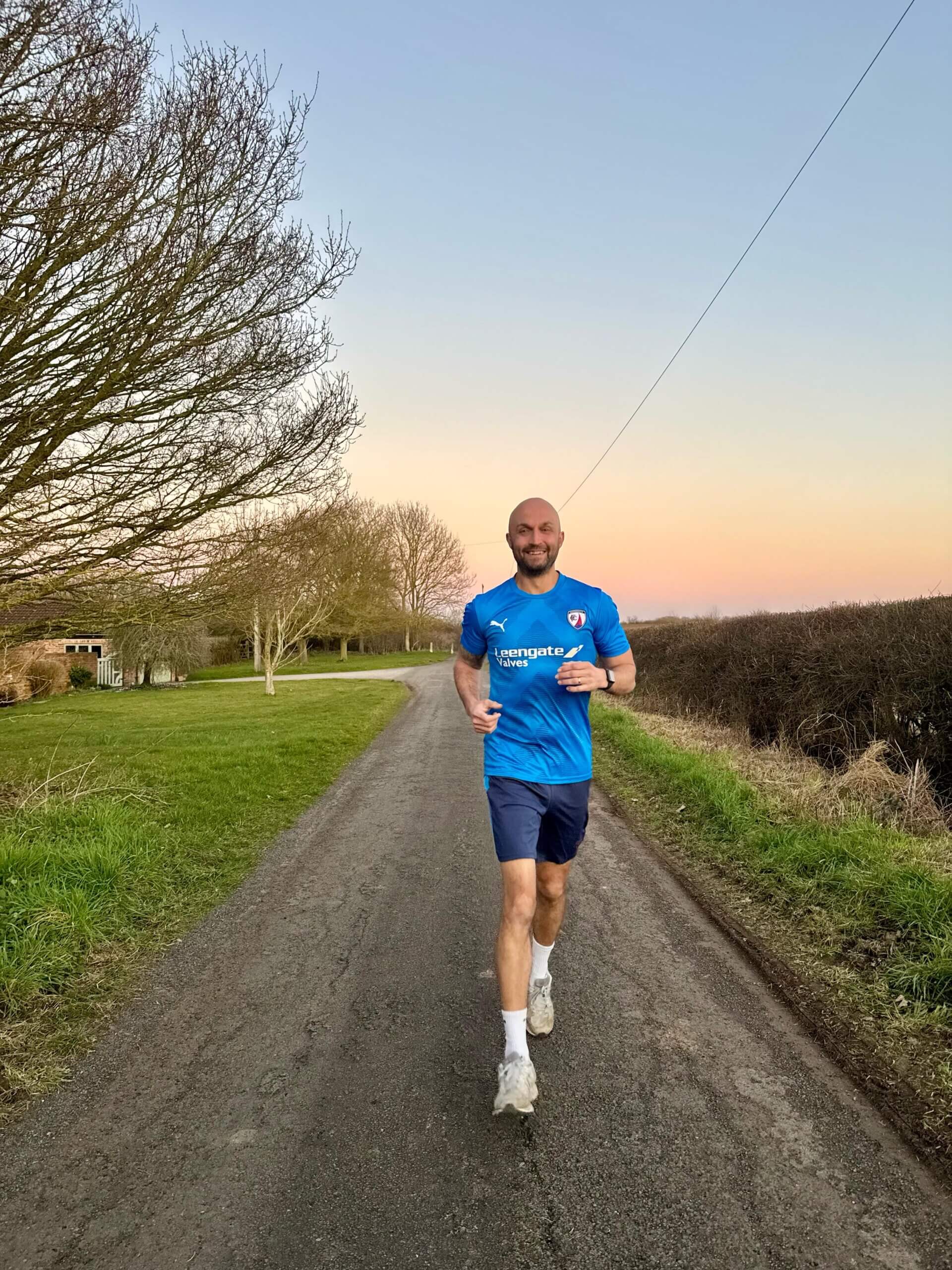Arran Jaiswal running in the countryside.