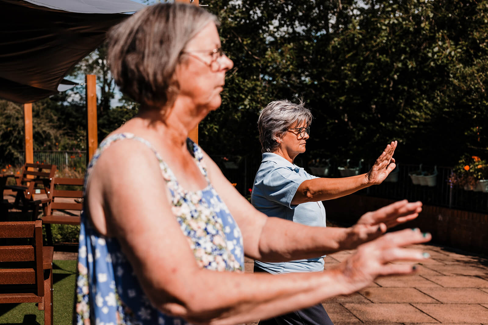Patient and Ashgate Hospice Physiotherapist taking part in tai chi.
