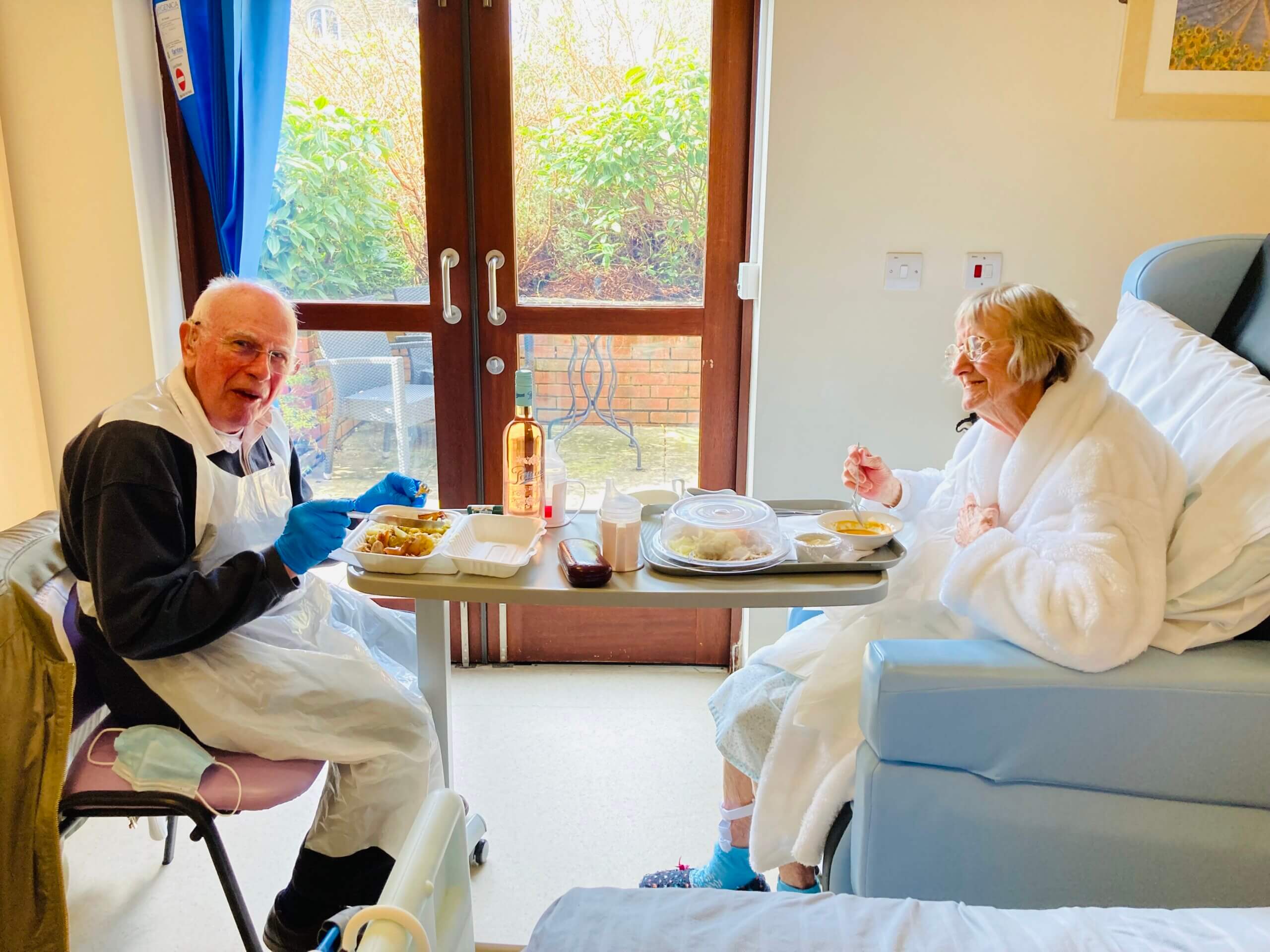 Barry and Sue sitting together in Sue's room at Ashgate Hospice eating together.