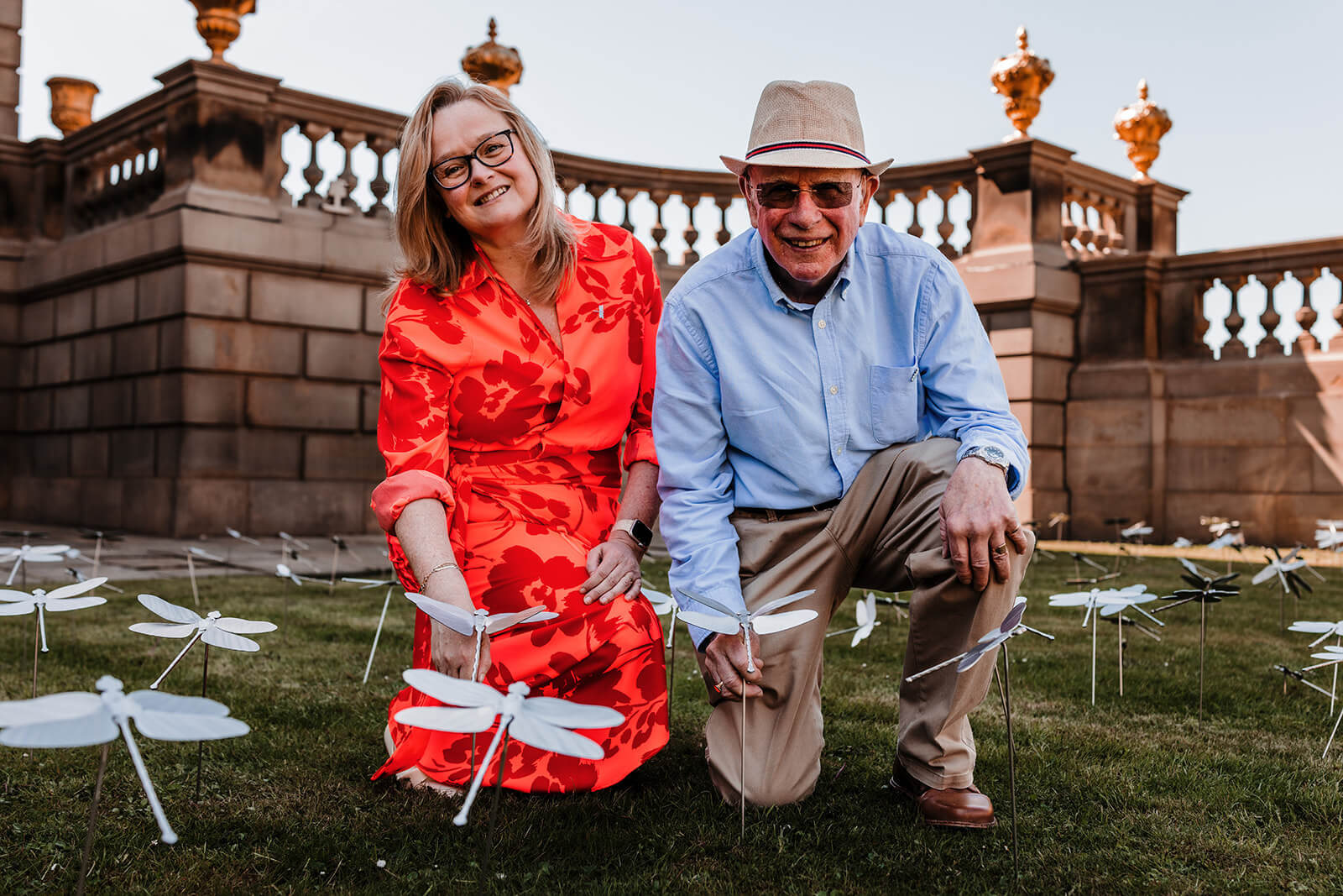 Clare and Barry knelt down amongst stainless steel dragonflies.