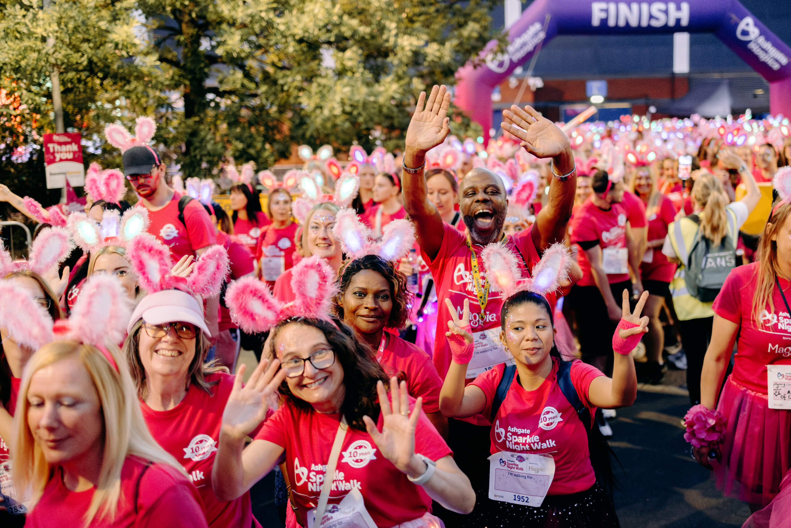 People waving at the camera at the Sparkle Night Walk. Photo by EKR Pictures.