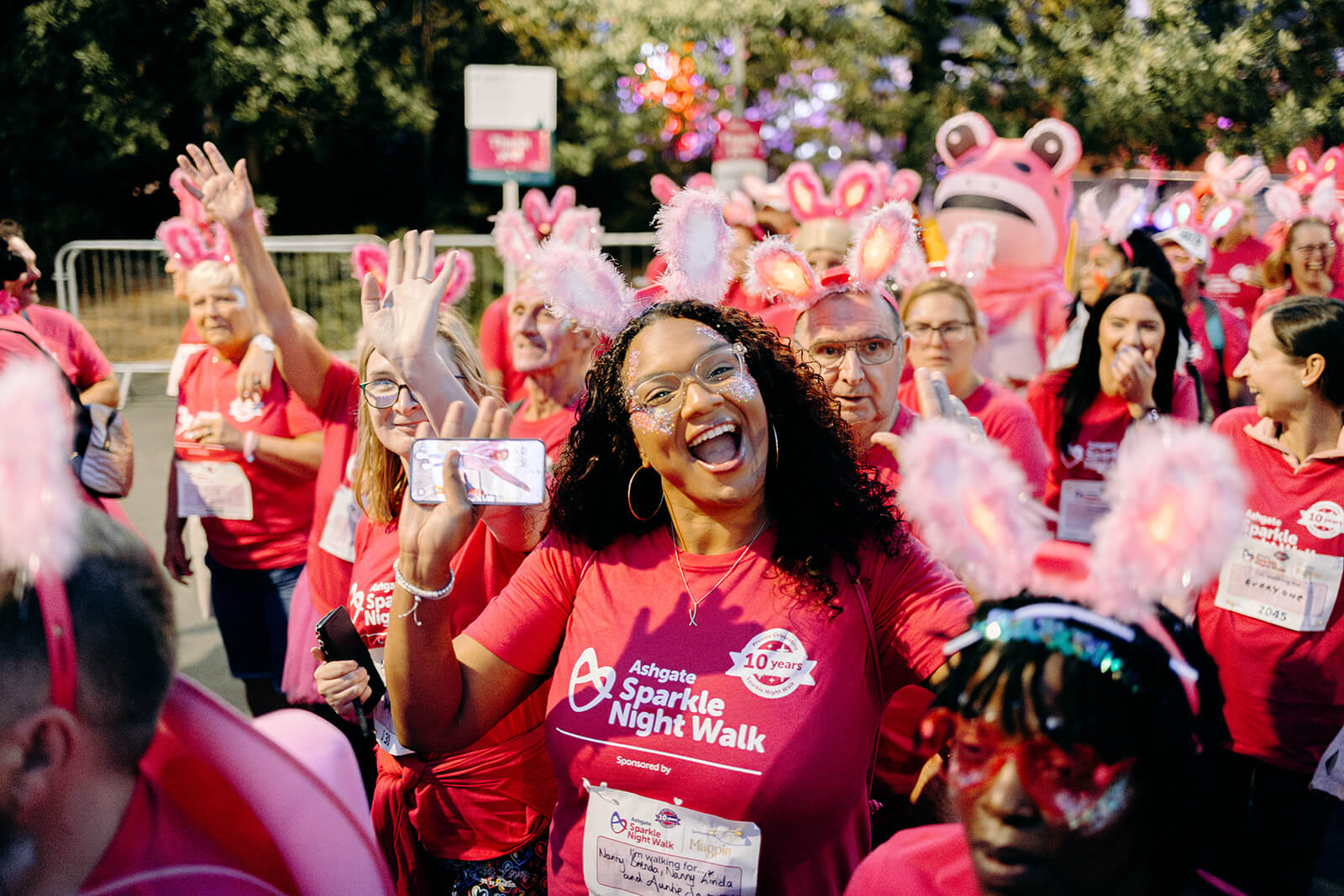 Sparkle Night Walk participant waving at the camera.