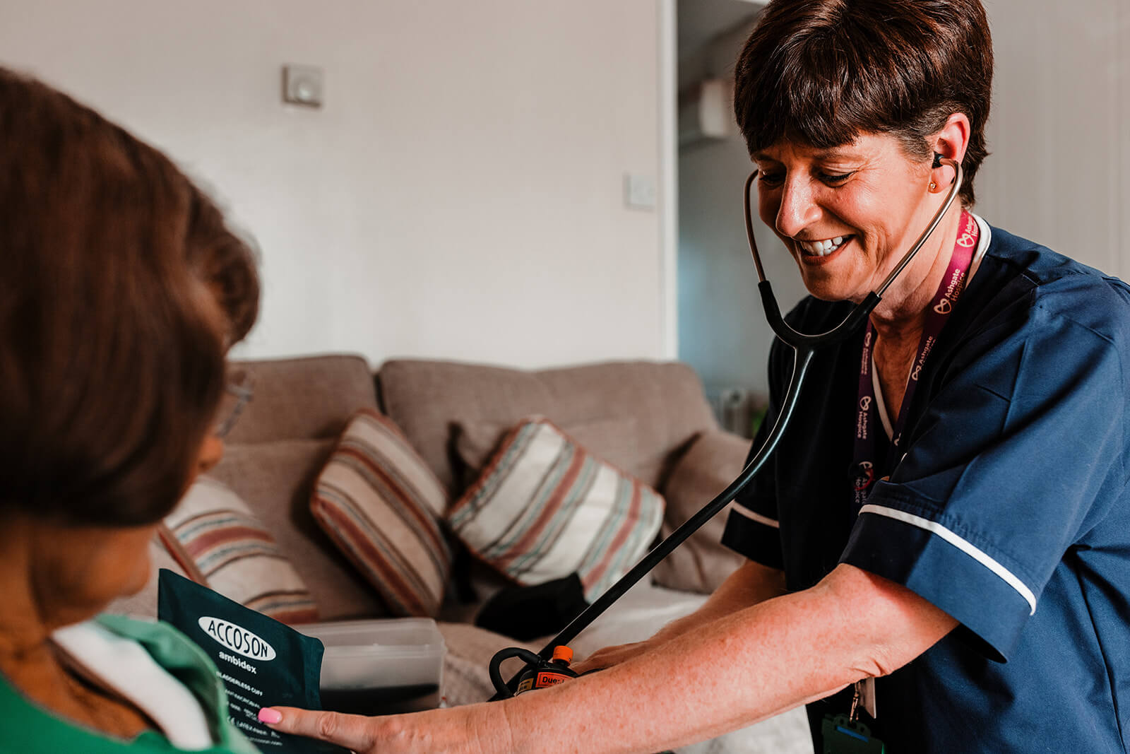 Nurse taking a patient's blood pressure.